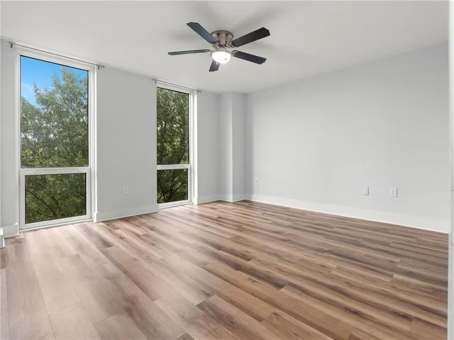 a view of empty room with wooden floor