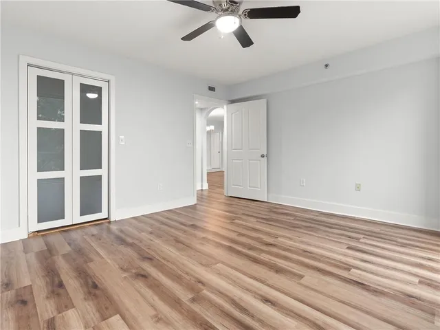 a view of an empty room and wooden floor