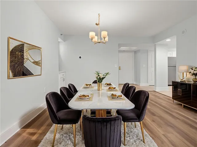 a view of a dining room with furniture wooden floor and a chandelier