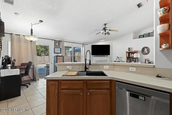 a kitchen with a sink cabinets and window