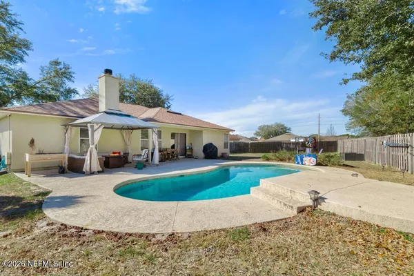 a view of a house with swimming pool and sitting area