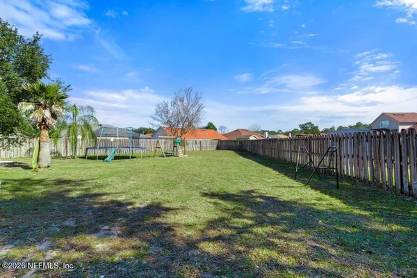 a view of backyard with tree