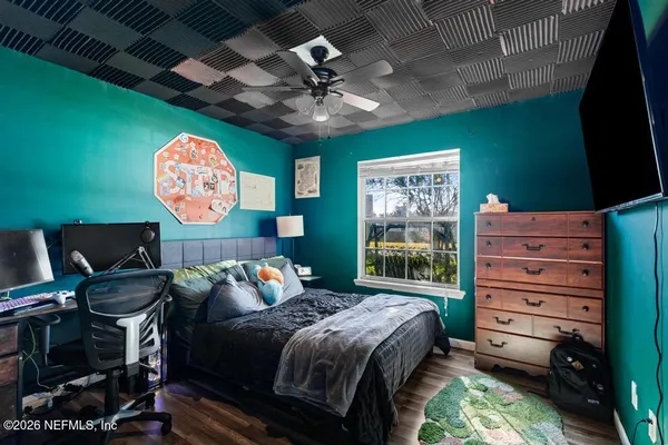 a bedroom with a bed and a bookshelf