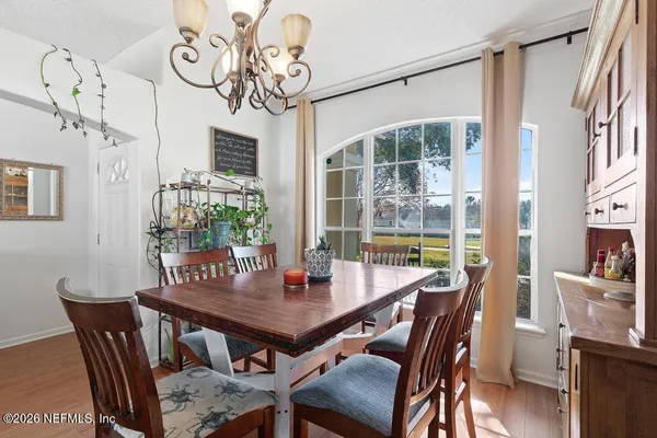 a view of a dining room with furniture window and wooden floor
