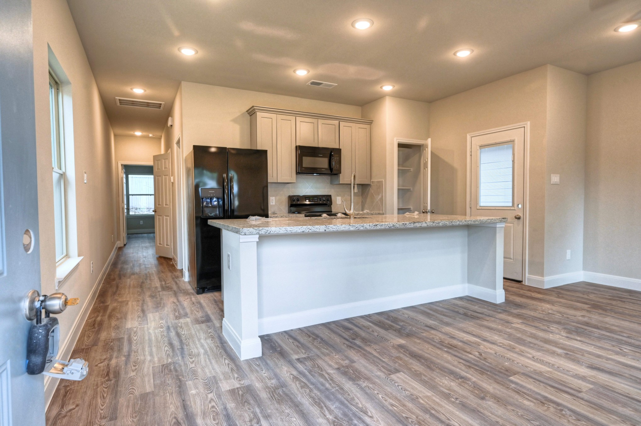 9173 Inwood Willis, TX 77318 - Photo 4 of 31 a kitchen with stainless steel appliances kitchen island granite countertop a stove a sink and a refrigerator