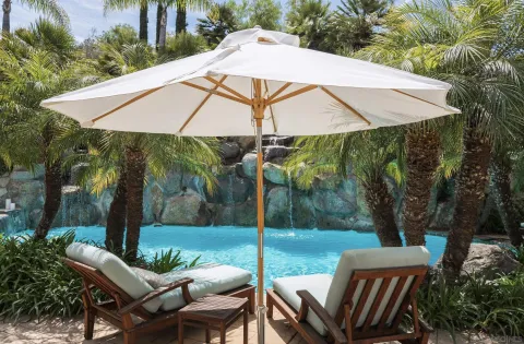 a view of a patio with table and chairs under an umbrella