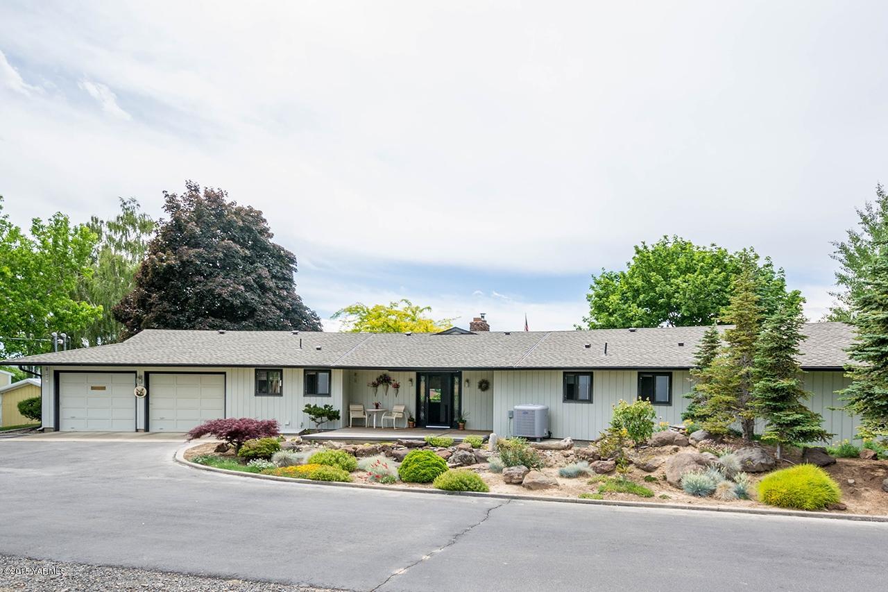 9530 Bittner Road Yakima, WA 98901 - Photo 1 of 28 a front view of a house with sitting area and garden