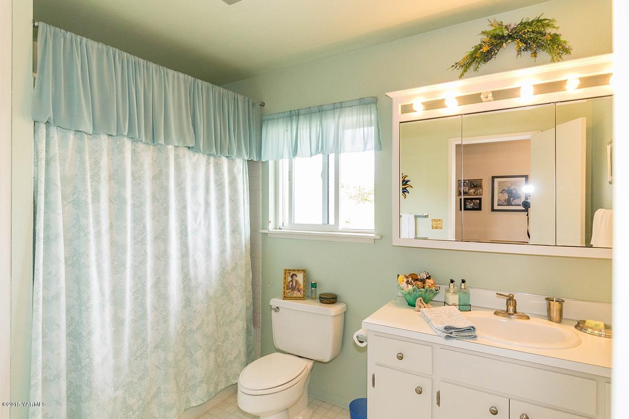9530 Bittner Road Yakima, WA 98901 - Photo 15 of 28 a bathroom with a sink a toilet and a mirror