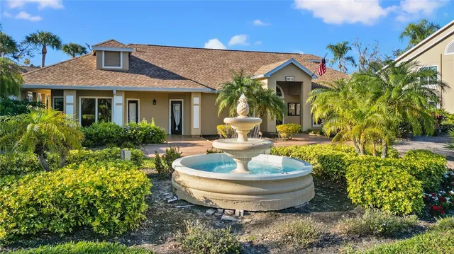 a view of a house with fountain and entertaining space