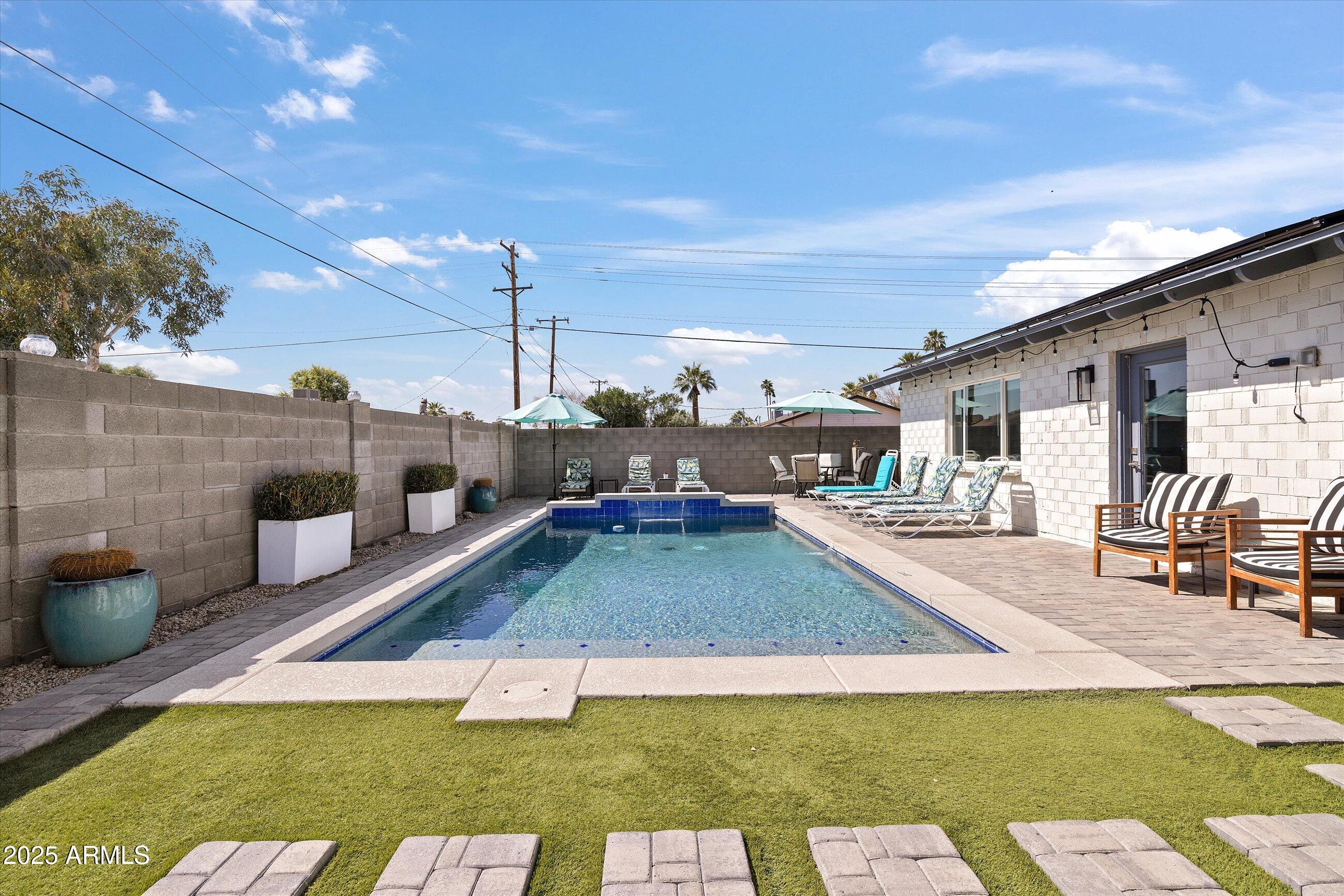 8201 East Piccadilly Road Scottsdale, AZ 85251 - Photo 1 of 26 a swimming pool view with a outdoor seating