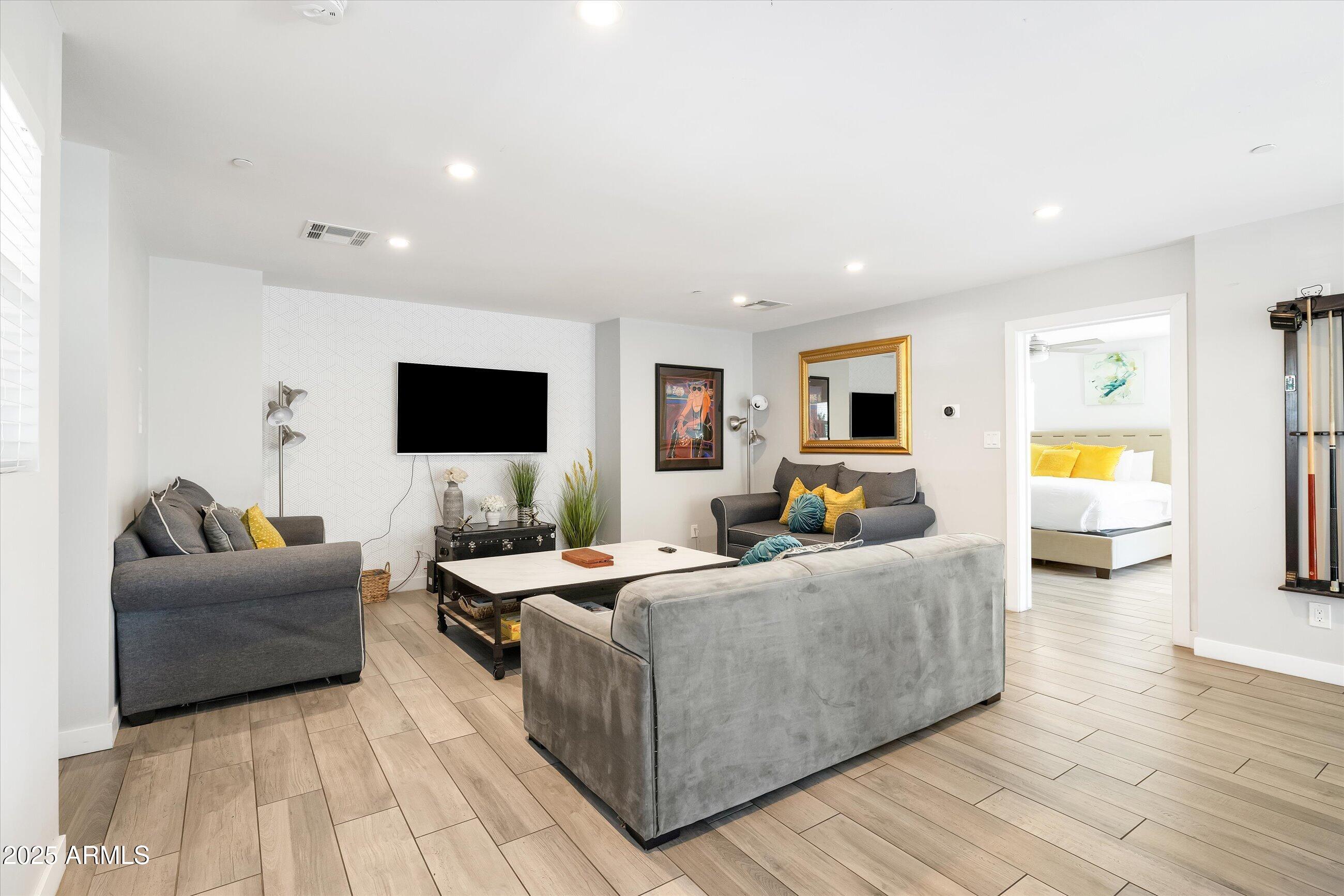 8201 East Piccadilly Road Scottsdale, AZ 85251 - Photo 13 of 26 a living room with furniture and a flat screen tv
