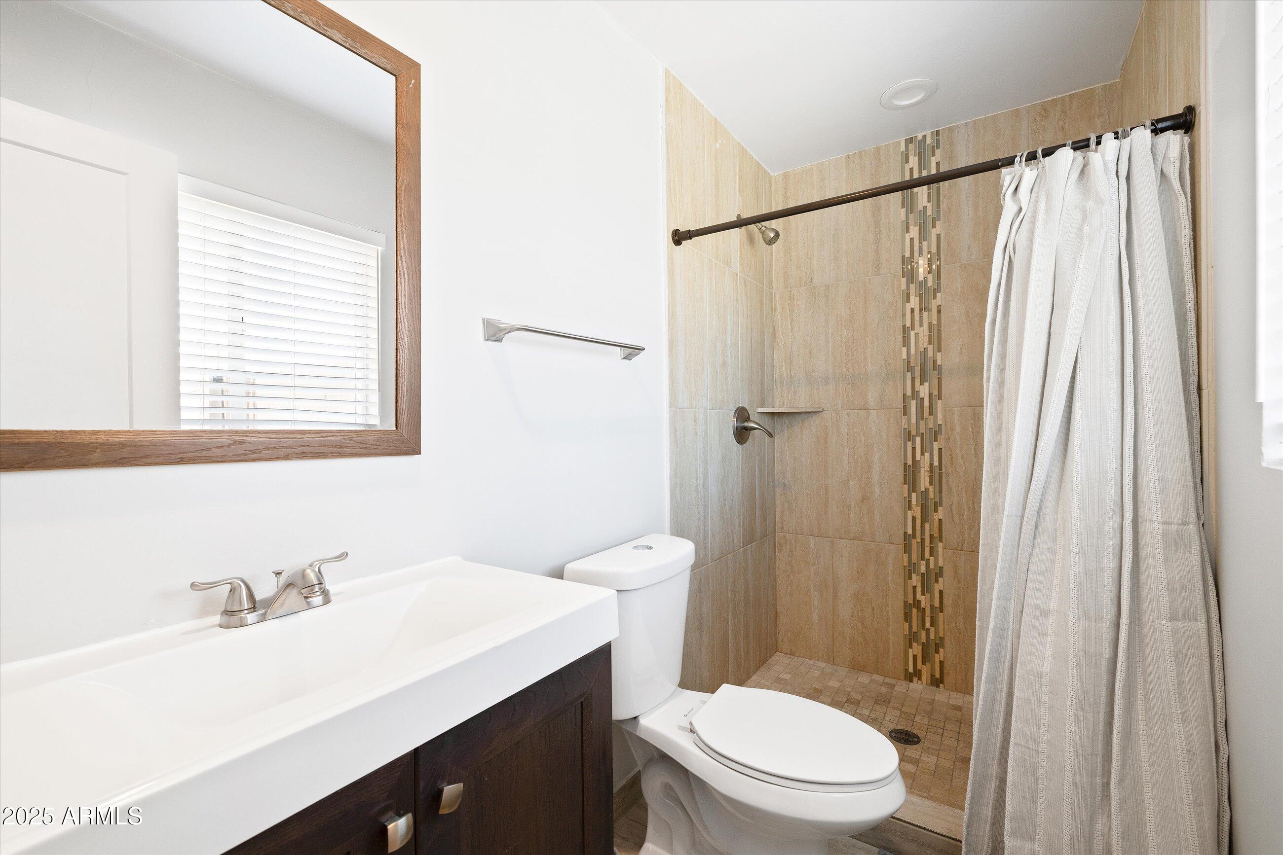 8201 East Piccadilly Road Scottsdale, AZ 85251 - Photo 16 of 26 a bathroom with a sink a toilet and shower