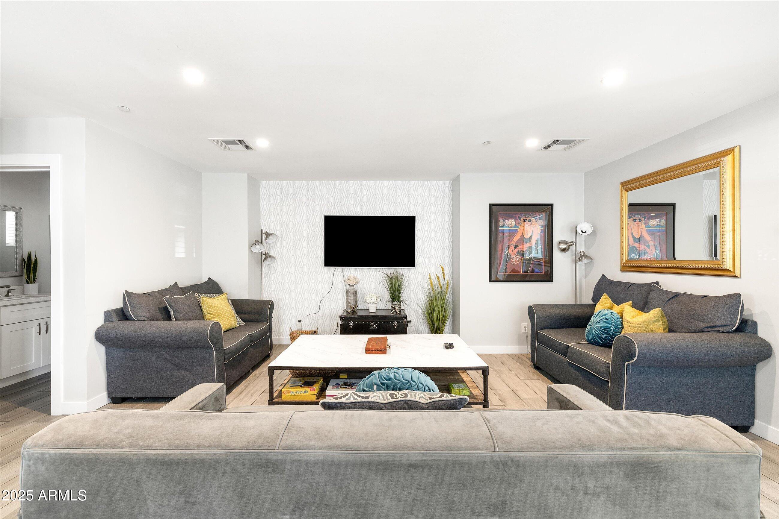 8201 East Piccadilly Road Scottsdale, AZ 85251 - Photo 5 of 26 a living room with furniture and a flat screen tv