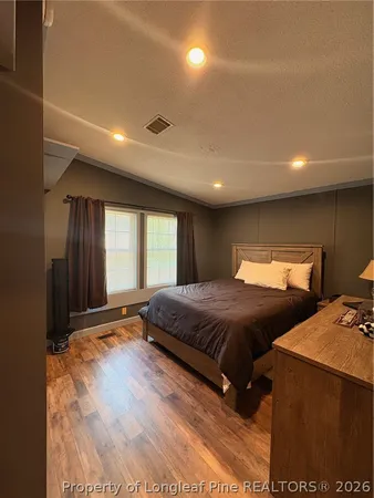 a spacious bedroom with two beds and a large window