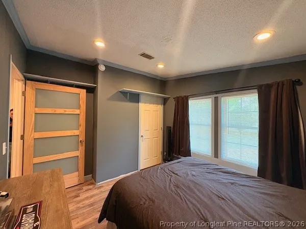 a bedroom with a large bed and a large window