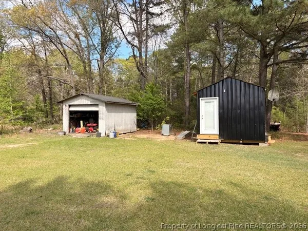 a view of a house with backyard and sitting area