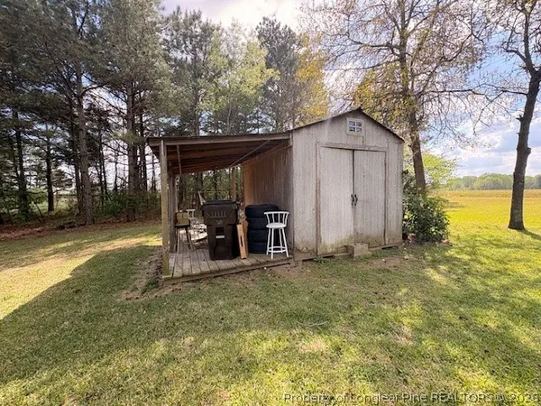 a backyard of a house with barbeque oven and outdoor seating