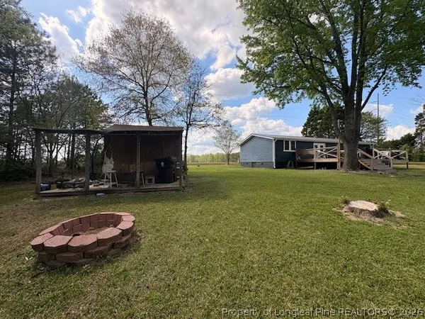 a swimming pool with outdoor seating and yard