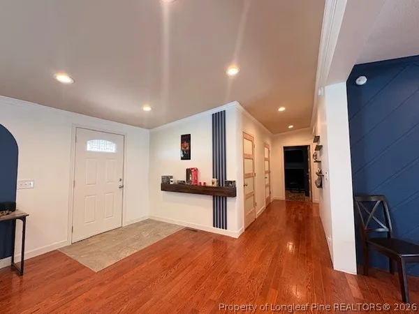 a view of a living room hardwood floor and a kitchen