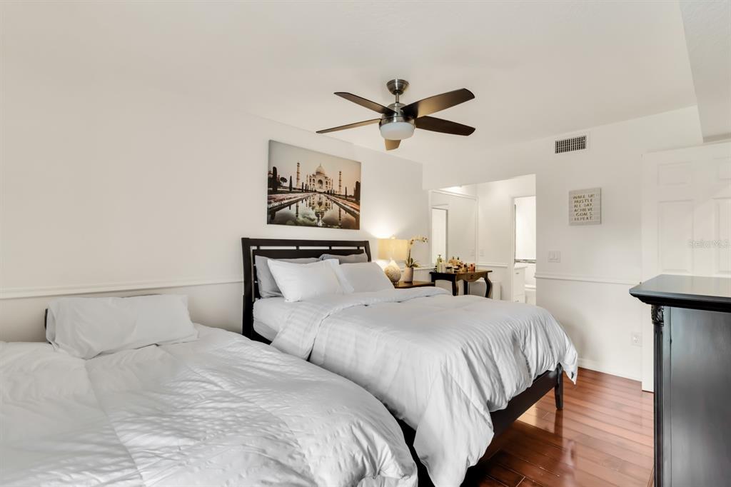 4434 Middlebrook Road, Unit 4 Orlando, FL 32811 - Photo 11 of 31 a bedroom with a bed and a chandelier