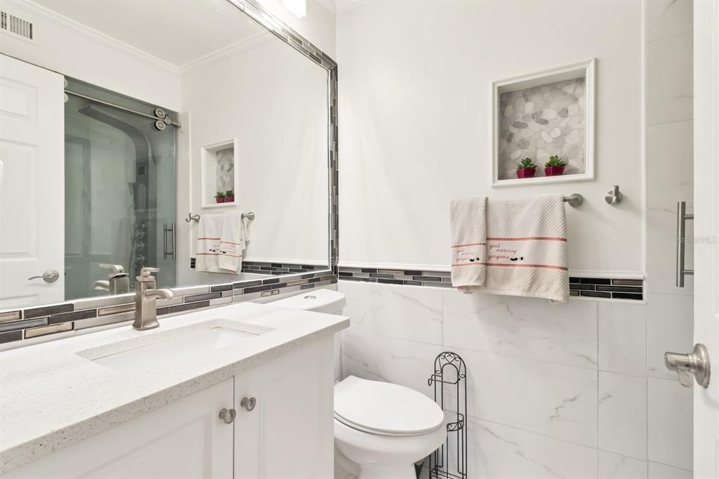 4434 Middlebrook Road, Unit 4 Orlando, FL 32811 - Photo 13 of 31 a bathroom with a toilet sink and mirror