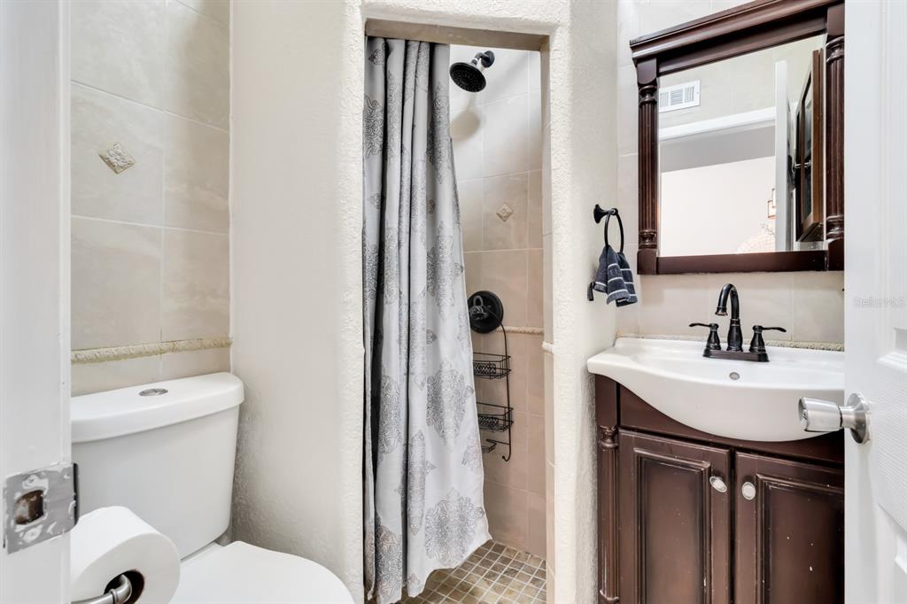 4434 Middlebrook Road, Unit 4 Orlando, FL 32811 - Photo 19 of 31 a bathroom with a sink toilet and shower