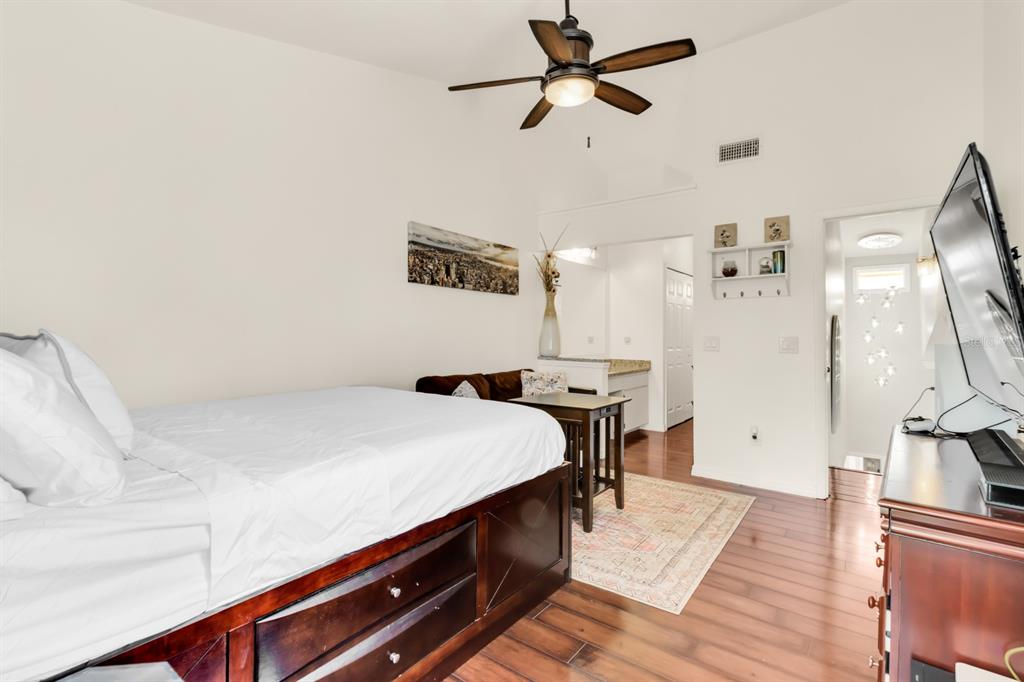 4434 Middlebrook Road, Unit 4 Orlando, FL 32811 - Photo 22 of 31 a room with a bed and a chandelier