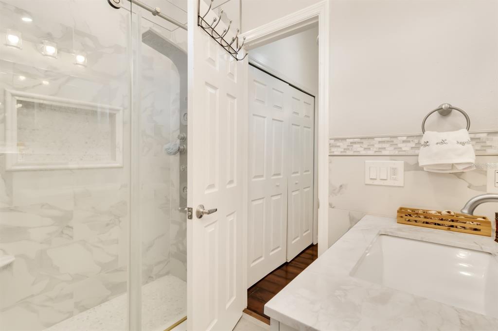 4434 Middlebrook Road, Unit 4 Orlando, FL 32811 - Photo 25 of 31 a bathroom with a sink a mirror and a shower