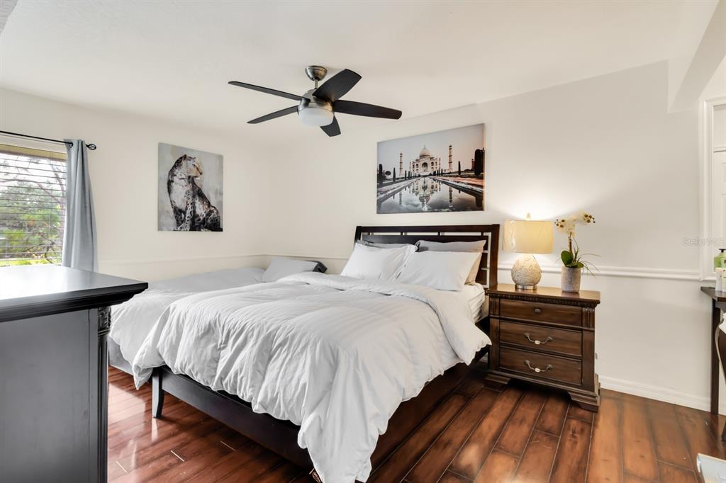 4434 Middlebrook Road, Unit 4 Orlando, FL 32811 - Photo 9 of 31 a bedroom with a bed and wooden floor