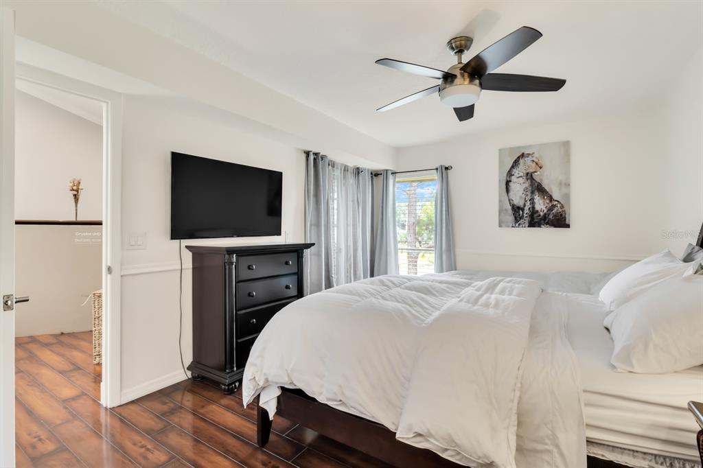 4434 Middlebrook Road, Unit 4 Orlando, FL 32811 - Photo 10 of 31 a bedroom with a bed and a flat screen tv