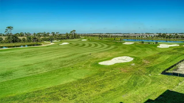 a bedroom with a bed and a flat tv screen on dresser