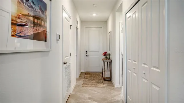 a bedroom with a large bed and a lamp