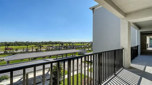 a living room with furniture a flat screen tv and a floor to ceiling window