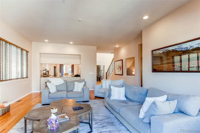 a living room with furniture and a painting