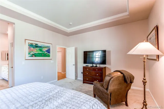 a bedroom with bed and a flat screen tv