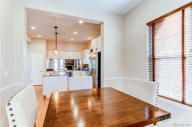 a large white kitchen with kitchen island a stove a sink and a refrigerator