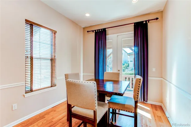 a dining room with furniture and wooden floor