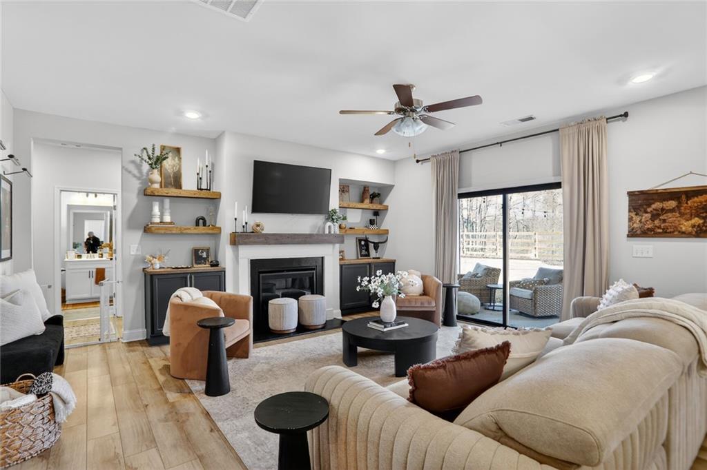 454 Carmichael Circle Canton, GA 30115 - Photo 1 of 30 a living room with furniture a fireplace and a flat screen tv