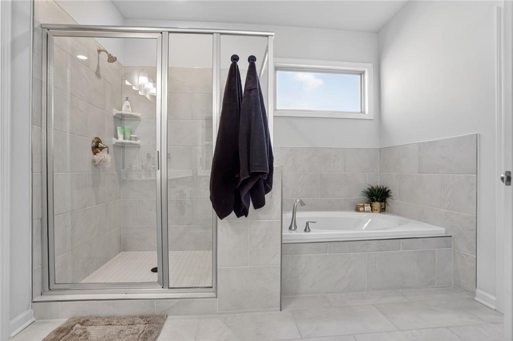 454 Carmichael Circle Canton, GA 30115 - Photo 21 of 30 a bathroom with a sink a toilet and shower