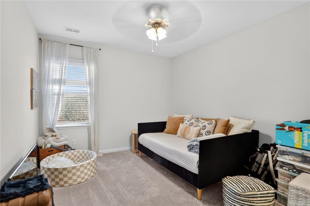 454 Carmichael Circle Canton, GA 30115 - Photo 23 of 30 a living room with furniture and a chandelier