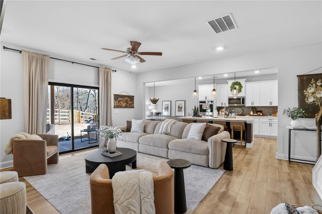 454 Carmichael Circle Canton, GA 30115 - Photo 9 of 30 a living room with furniture kitchen view and a large window