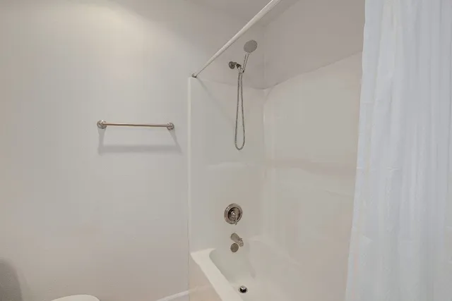a bathroom with a bathtub and a shower