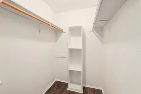 a view of walk in closet with clothes