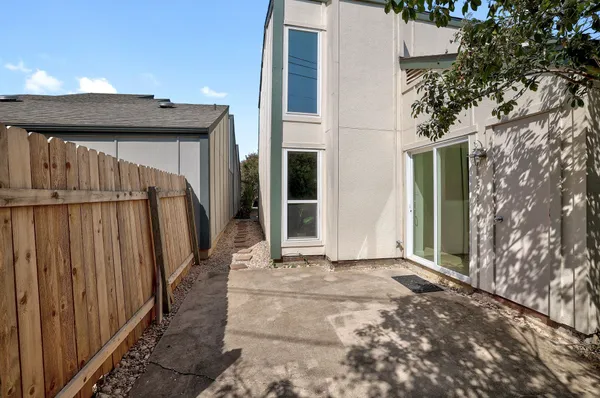 a view of a house with a wooden fence