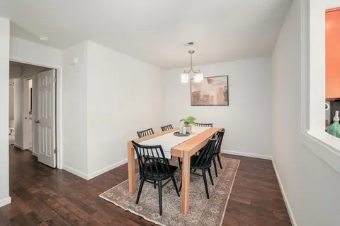 a view of a dining room with furniture and wooden floor