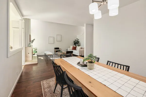 a view of a dining room with furniture wooden floor and chandelier