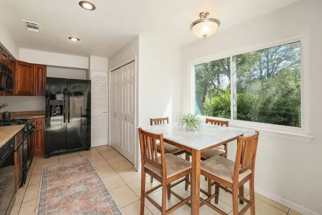 a room with a wooden table and chairs