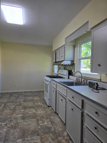 a kitchen with sink cabinets and window