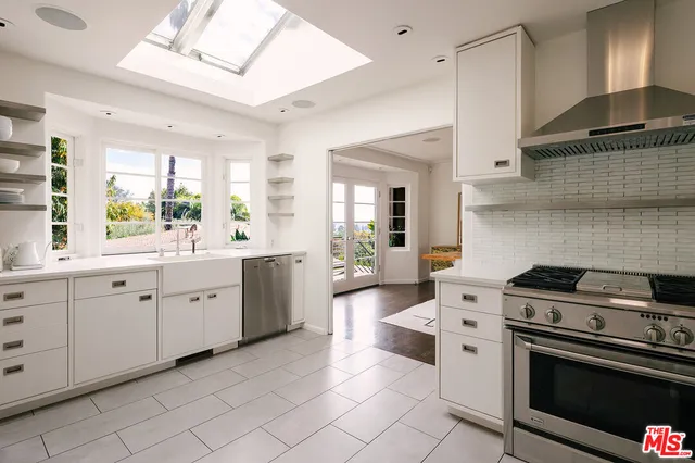 a kitchen with counter top space sink and window