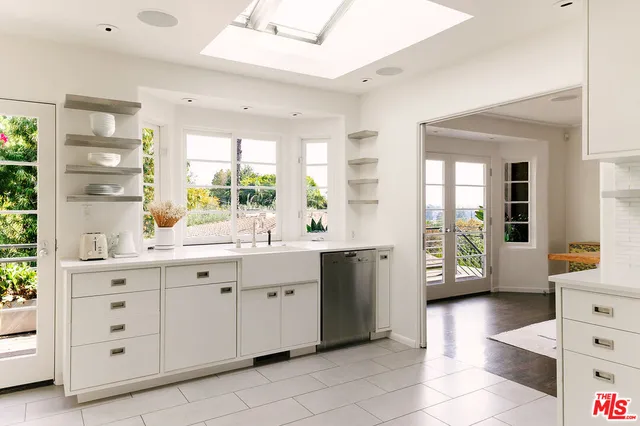 a kitchen with cabinets and window